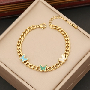 Golden stainless steel chain bracelet featuring colorful butterfly charms on jewelry box