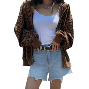 Detailed view of leopard print hooded jacket paired with denim shorts and casual accessories