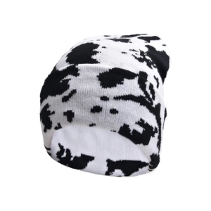 Winter knitted beanie with black and white cow pattern for cozy outdoor street style