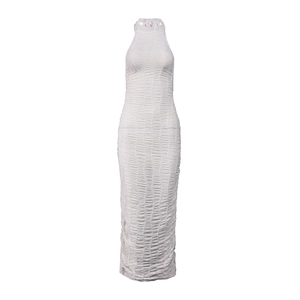 Detailed view of white halter maxi dress featuring fine pleats and wavy textured fabric