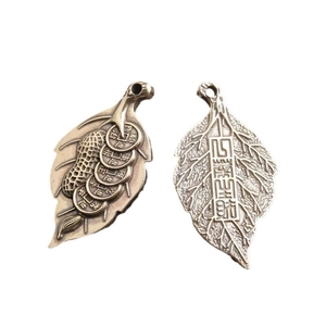 Traditional brass leaf pendants with peanut and ancient coin patterns for good luck