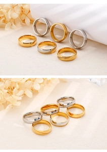 Detailed view of two-tone stainless steel couple rings with cubic zirconia settings