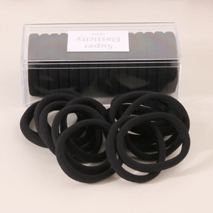 Macro shot of 15-pack high elasticity black hair ties in a clear rectangle box