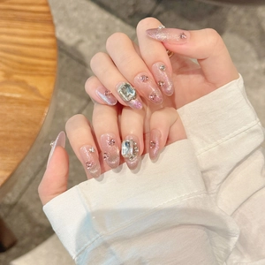 Long stiletto press-on nails with purple cat-eye finish and luxury silver rhinestones