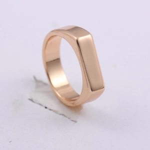 Close-up of polished rose gold rectangular flat top ring with minimalist metal finish