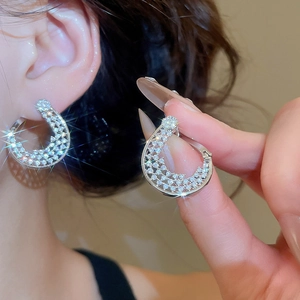 Vue détaillée de boucles d'oreilles fleur torsadée en plaqué or 18K et zircons brillants