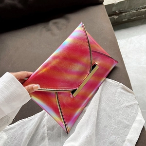 Detail of pink gradient envelope clutch with gold metal hardware and laser finish