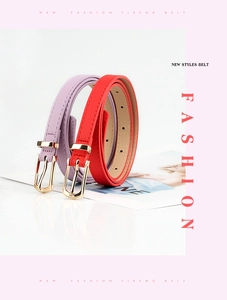 Detail view of purple and red thin PU leather belts featuring elegant gold metal buckles