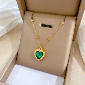 Minimalist titanium steel gold chain necklace with a green heart pendant in a jewelry box
