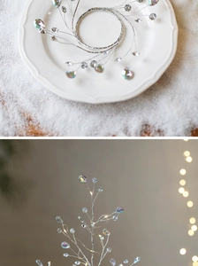 Macro detail of lighted crystal branch wreath with silver wire and colorful LED beads