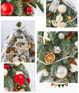 Detail of Christmas tree decor featuring red baubles, pine cones, and knitted ornaments