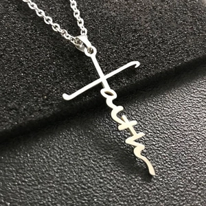 Close-up of silver stainless steel necklace with cursive faith word cross pendant