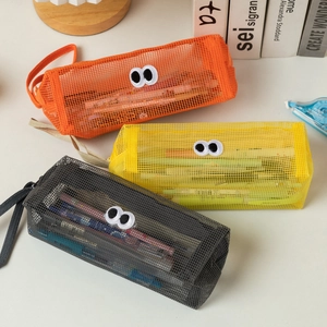 Detailed view of three mesh pencil bags in orange, yellow, and grey with big eye patches