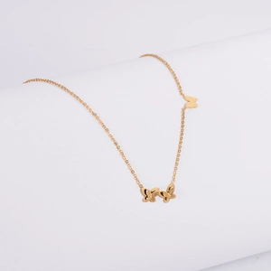 Elegant gold 3D butterfly necklace with frosted wings on minimalist display stand