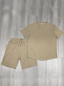 Detail of khaki men's summer set showing waffle texture on short sleeve top and drawstring shorts