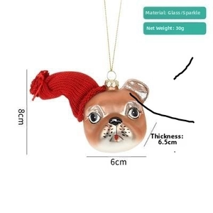 Detailed view of creative French Bulldog glass ornament with red hat for Christmas tree
