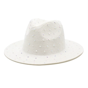 Detailed texture of white paper straw hat adorned with shimmering colorful rhinestones