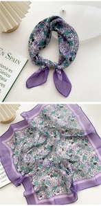 Detail of purple floral cotton linen scarf showing soft texture and delicate hem stitching
