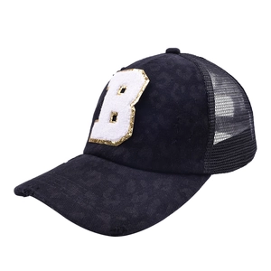 Close-up of black mesh trucker hat featuring leopard print and sequined letter B patch