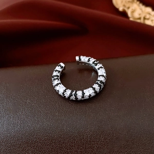 Macro detail of French retro silver ring featuring black and white zircon stone inlay