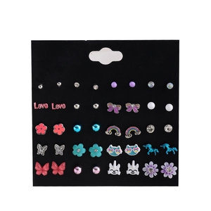 25 pairs of assorted stud earrings featuring unicorns butterflies and pearls on black card