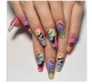 Detail of long trapezoid press-on nails featuring graffiti skulls and rhinestones
