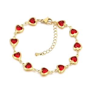 Golden stainless steel bracelet featuring red heart-shaped glass gemstones on white background