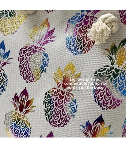 Detail shot of woven linen texture with a colorful rainbow pineapple print on a tote bag