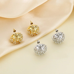 Exaggerated stainless steel half-sphere stud earrings with white pearls on silk fabric