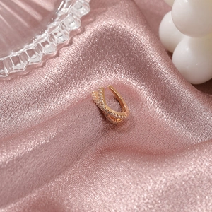 Minimalist rose gold criss-cross ear cuff with pave cubic zirconia on pink silk