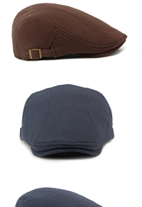 Detail view of cotton flat cap with vintage bronze metal buckle and fabric texture
