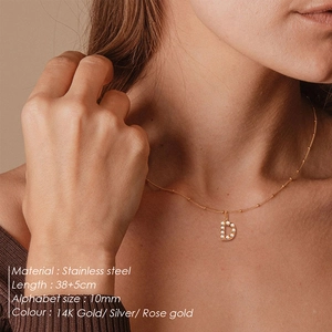 Detailed close-up of 14K gold plated stainless steel letter D pearl pendant necklace