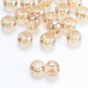 Macro detail of champagne gold large hole glass beads with high gloss finish for jewelry DIY