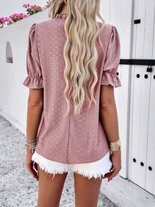 Rear view of pink hollow-out top featuring puff sleeves and ruffled cuffs details