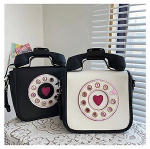Creative retro rotary telephone-shaped PU crossbody bags in black and white.