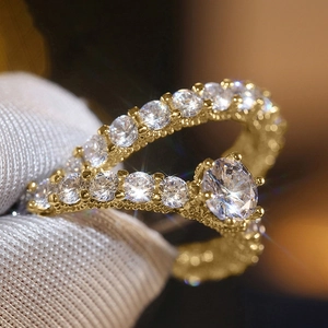 Macro shot of two-piece gold rings with full cubic zirconia pave and large solitaire diamond