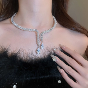 Detailed view of silver double-layered choker with pear-shaped zircon pendants on a model