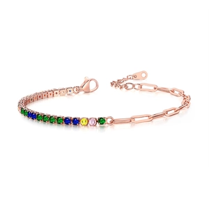 Macro detail of paperclip and rainbow zircon tennis chain with rose gold finish