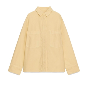 Detail of cream long-sleeved shirt featuring large chest pockets and a turnover collar