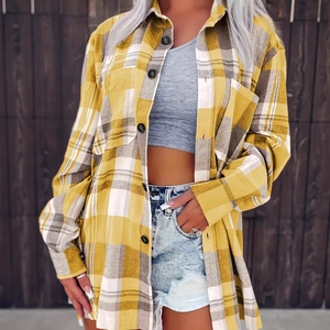 Detailed view of women's yellow plaid button-down shirt paired with denim shorts