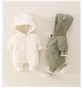 Detail of quilted baby romper featuring cute bear ears and elastic ribbed cuffs for warmth