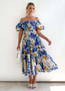 Detail of floral off-shoulder dress featuring puff sleeves and tiered skirt for summer