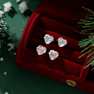 Detail of S925 silver and rose gold heart earrings with bows in a velvet gift box