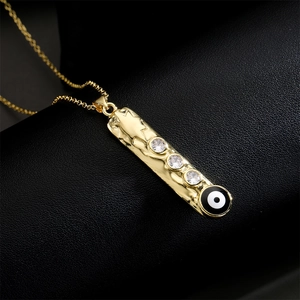 Gold vertical geometric bar necklace with evil eye pendant and zircon stones on black leather
