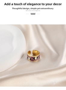 Detailed close-up of a gold adjustable evil eye ring with purple enamel on silk fabric