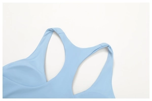 Detail of light blue racerback sports bra showing seamless stitching and elastic fabric