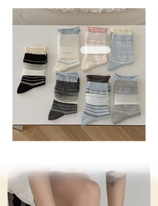 Detail view of striped cotton socks set in seven pastel colors with rolled cuffs