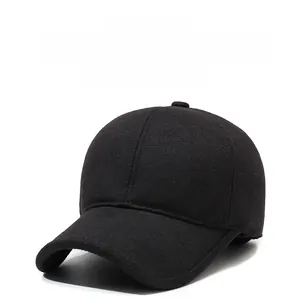 Detail of winter baseball cap with ear flaps and metallic shield emblem on side