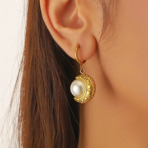 Elegant gold crescent moon pendant earrings with white pearl and heart relief textures