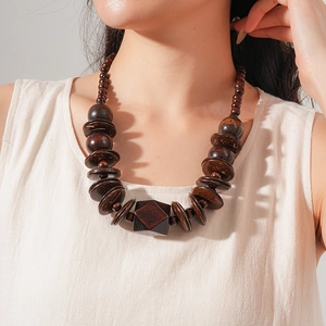 Detailed view of ethnic style necklace featuring faceted wood beads and coconut shells